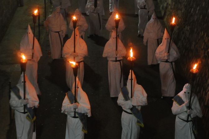 Penitents hold torches during a Good Friday procession April 3 in Sorrento, Italy. 