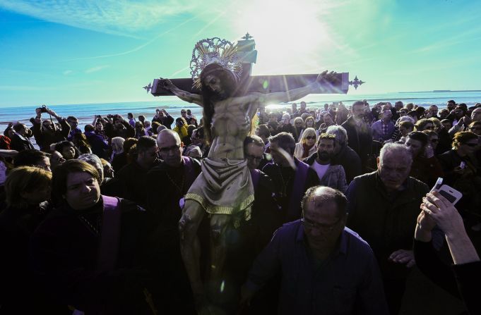 An effigy of Jesus Christ is at the center of a Holy Week procession on the beach in Valencia, Spain, on April 3.