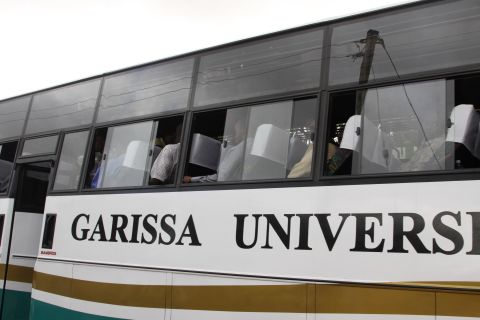 Students get on a bus at the gate of the school on April 3, 2015.