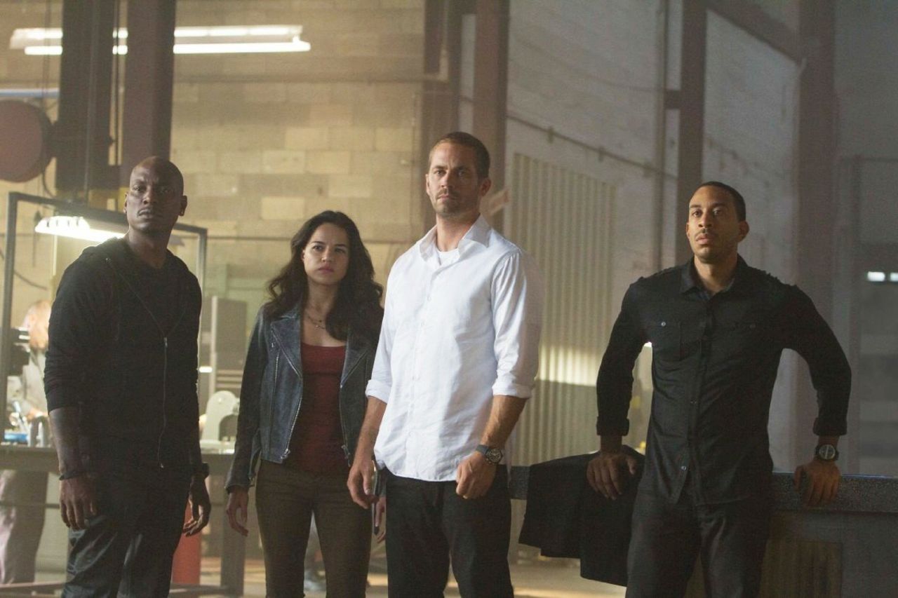 Walker with Tyrese Gibson, Michelle Rodriguez and Ludacris in "Furious 7," which had mostly completed filming when Walker died.  Many fans got emotional upon seeing Walker onscreen in the movie, which earned $143 million its first weekend.
