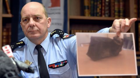 French Gen. David Galtier holds up a picture of the second black box from Germanwings 9525 during a news conference in Marseille, France, on Thursday, April 2. The flight data recorder shows that co-pilot Andreas Lubitz purposely used the controls to speed up the plane's descent, investigators said. 