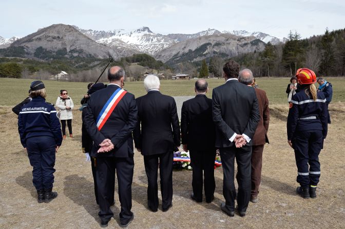 French government officials observe a moment of silence for <a href="index.php?page=&url=http%3A%2F%2Fwww.cnn.com%2F2015%2F03%2F24%2Fworld%2Fgallery%2Ffrance-plane-crash%2Findex.html" target="_blank">Germanwings Flight 9525</a> near the crash site Friday, April 3, in Le Vernet, France. 