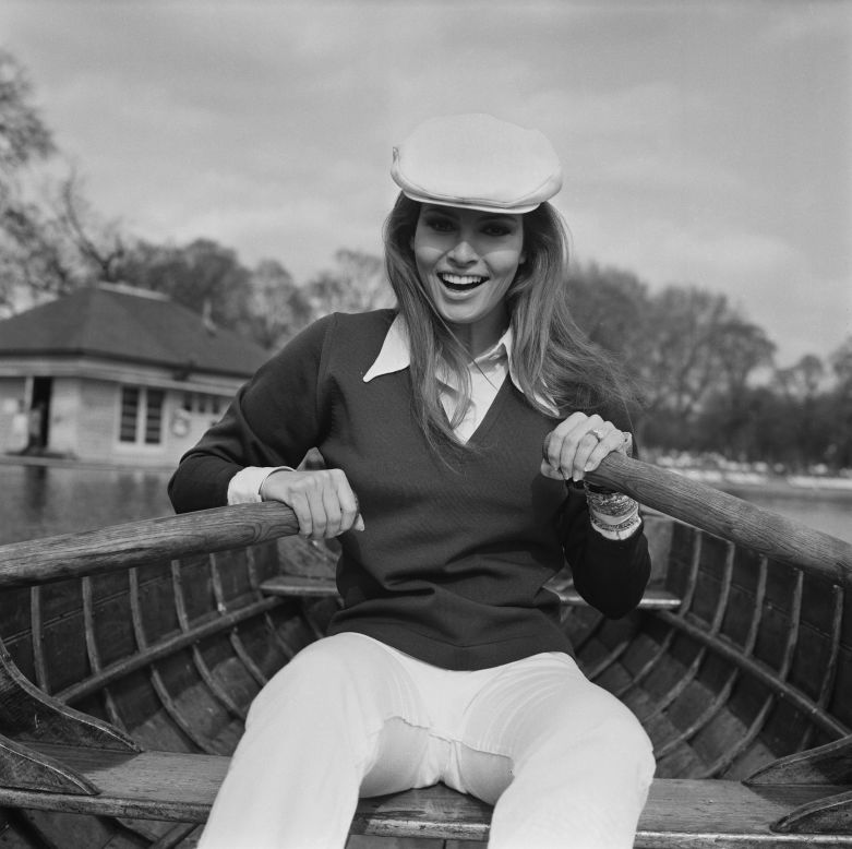 American actress and model Raquel Welch sports  flat cap and smart shirt and trousers while rowing on London's Serpentine, in 1969.