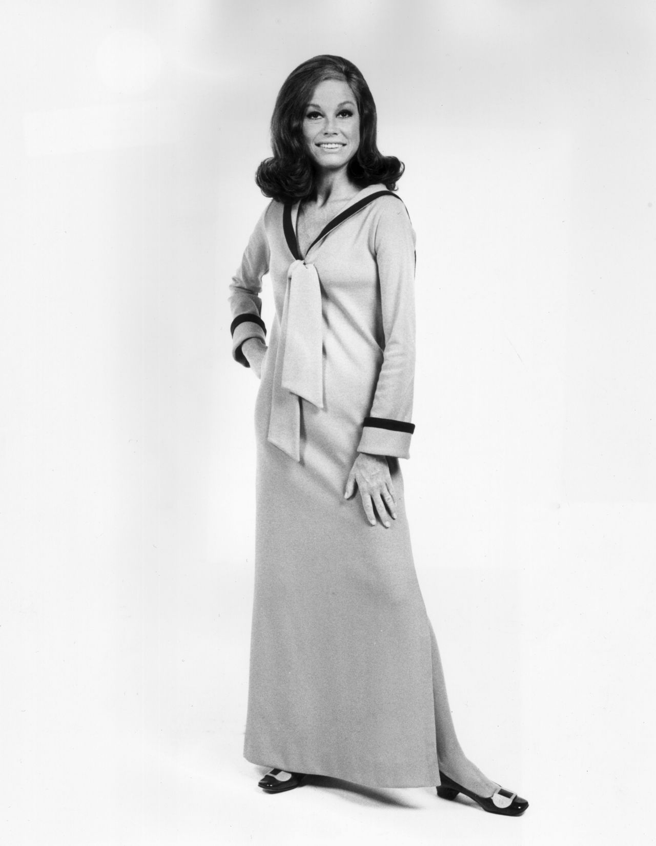 American actress Mary Tyler Moore opts for a more demure full-length dress with nautical collar, in this 1974 image.  