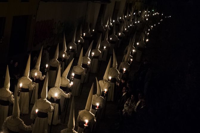 Penitents of the Jesus Yacente brotherhood take part in a Holy Week procession in Zamora, Spain, on Friday, April 3.