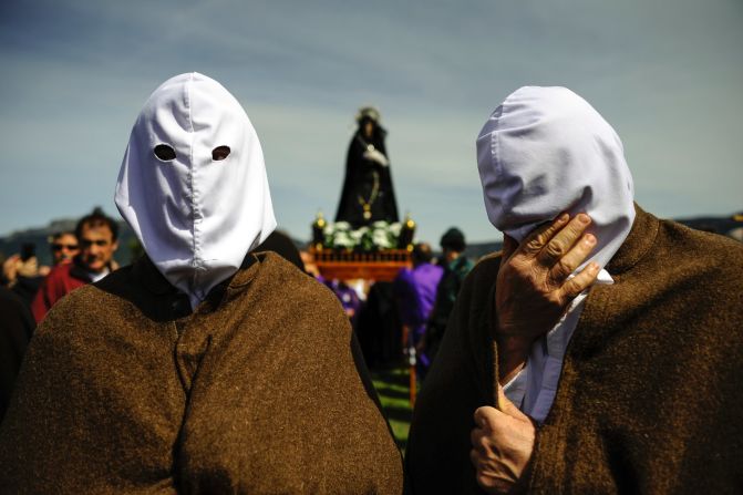 A masked penitent from La Santa Vera Cruz brotherhood takes part in an Easter procession known as Los Picaos in the small Spanish village of San Vicente de la Sonsierra on April 3.