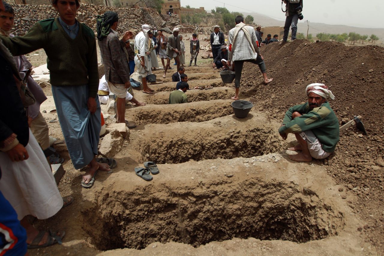 Yemenis dig graves on Saturday, April 4, to bury the victims of a reported airstrike by the Saudi-led coalition in the village of Bani Matar, Yemen.