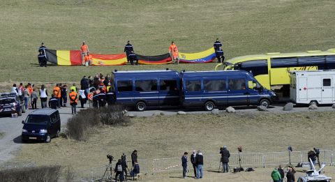 Relatives of the <a href="http://www.cnn.com/2015/03/24/world/gallery/france-plane-crash/index.html" target="_blank">Germanwings Flight 9525</a> crash victims arrive on Saturday, April 4, at a ceremony as rescuers hold flags of the late passengers' nationalities in the village of Le Vernet. Flight 9525 was carrying 150 people when it crashed in the French Alps in March. It was traveling from Barcelona, Spain, to Dusseldorf, Germany.