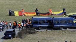 Relatives of the Germanwings  crash victims arrive on April 4, to attend a ceremony as rescuers hold flags of the late passengers' nationalities in the village of Le Vernet.