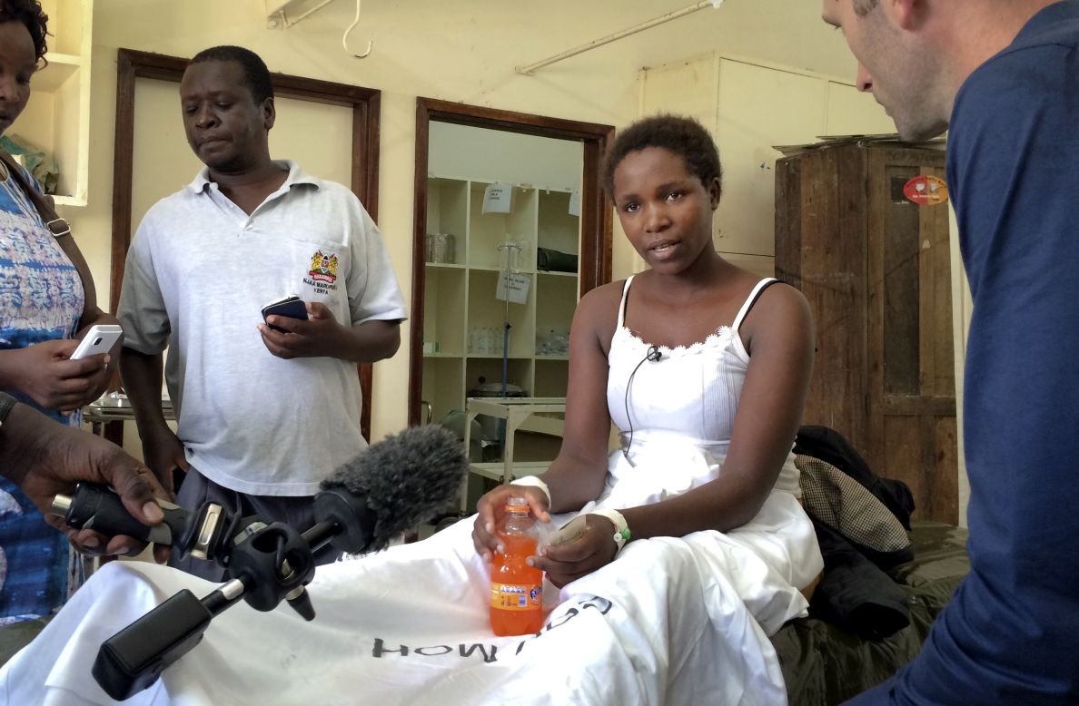 Survivor Cynthia Cheroitich speaks to a television reporter at a hospital ward in Garissa on April 4, 2015. Cheroitich told CNN she hid in a closet, covering herself.