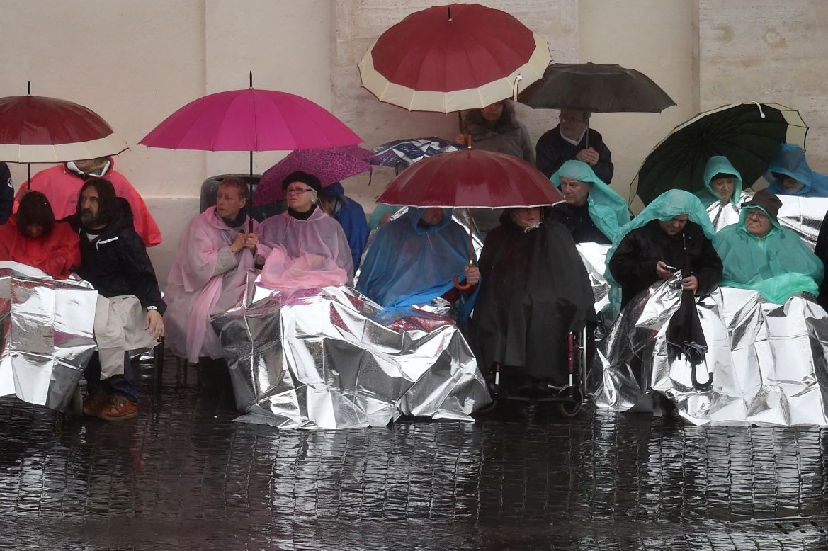 The faithful came well equipped to deal with the weather as they waited for Pope Francis.