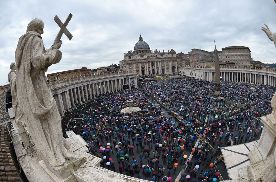 Worshipers shelter under umbrellas in heavy rain during the Easter Mass at St Peter's Square on April 5, 2015.