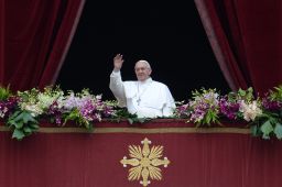 Pope Francis greets the crowd from St. Peter's Basilica at the Vatican on Sunday.