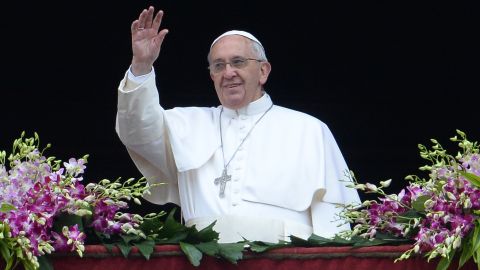Pope Francis greets the crowd from St. Peter's Basilica at the Vatican on Sunday.