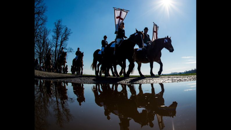 Easter horsemen ride near Luebbenau, Germany, on April 5.  In the Sorbian residential areas of Lusatia, it's an annual tradition for horsemen wearing festive attire to join the traditional Easter procession to announce the resurrection of Jesus Christ in the neighboring towns with prayers and songs. 