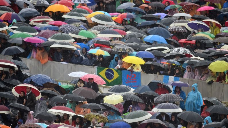 Worshippers hold umbrellas under heavy rain during the Easter Mass at St. Peter's Square in the Vatican on April 5.
