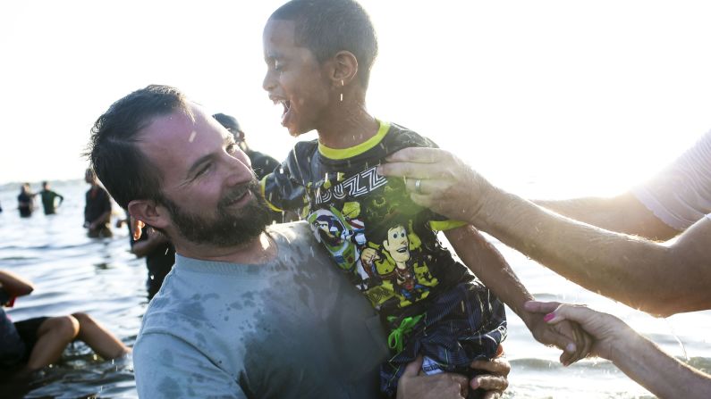 Pastor Ryan Marr holds DaShawn Murzyn, 7, after he was baptized during Calvary Chapel's Sonrise Baptism Service on Easter morning in a park in St. Petersburg, Florida. The church has been doing the baptism service for 30 years and had 150 people signed up to be baptized in the bay this year.
