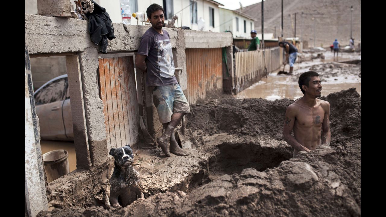 A man digs a gutter to drain water from his house in Copiapo on Monday, March 30. 