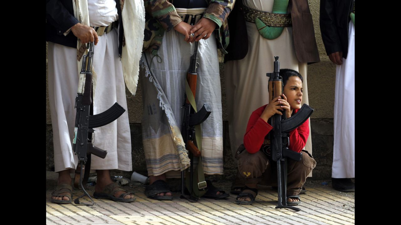 A Yemeni boy holds a rifle as Houthi supporters attend a rally in Sanaa, Yemen, on Sunday, April 5, protesting airstrikes carried out by a Saudi-led coalition against Houthi rebels. 