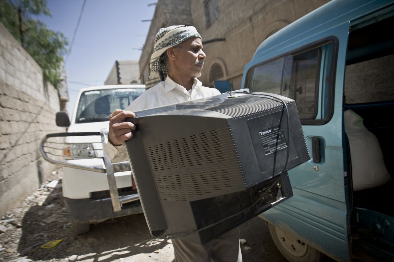 A Yemeni man loads a TV set into a van as he prepares to flee Sanaa on Thursday, April 2.