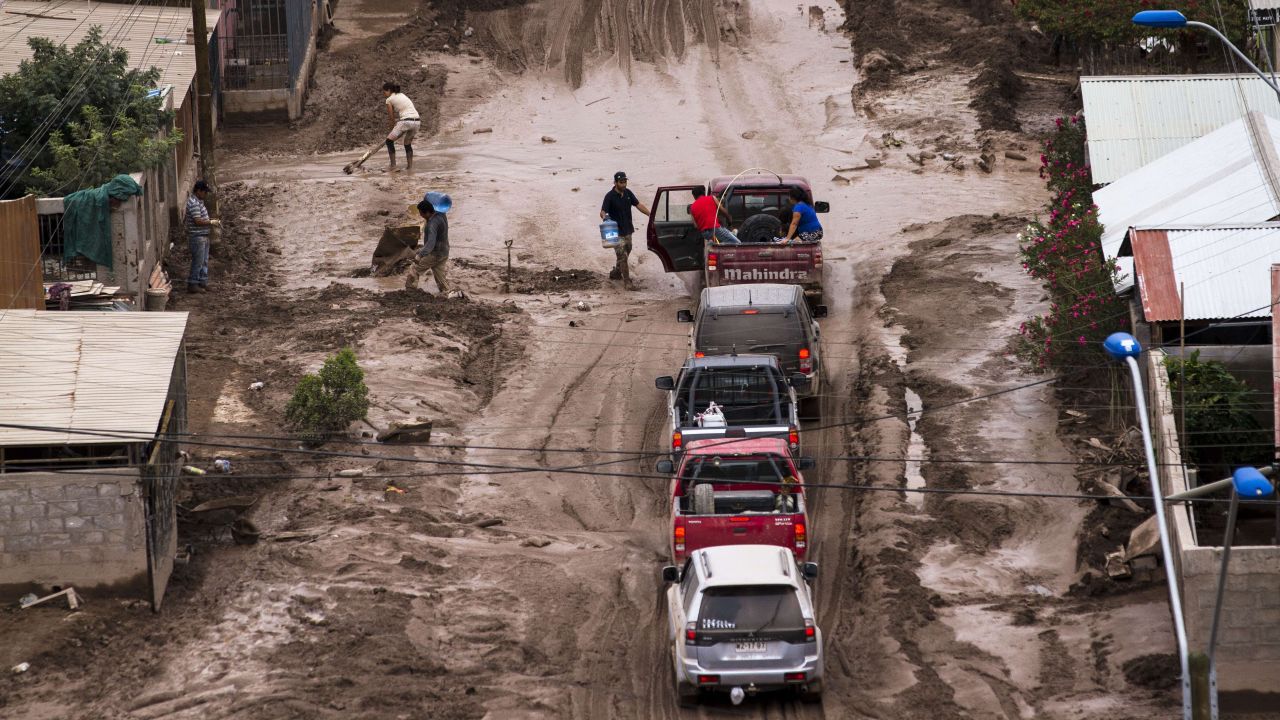 People cross a flooded street in Copiapo on March 30.