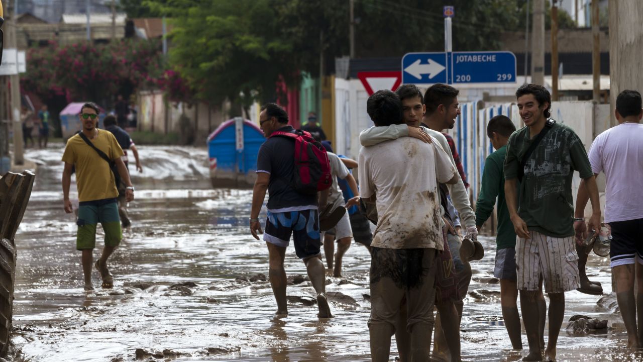 People walk along a flooded street in Copiapo on March 26.