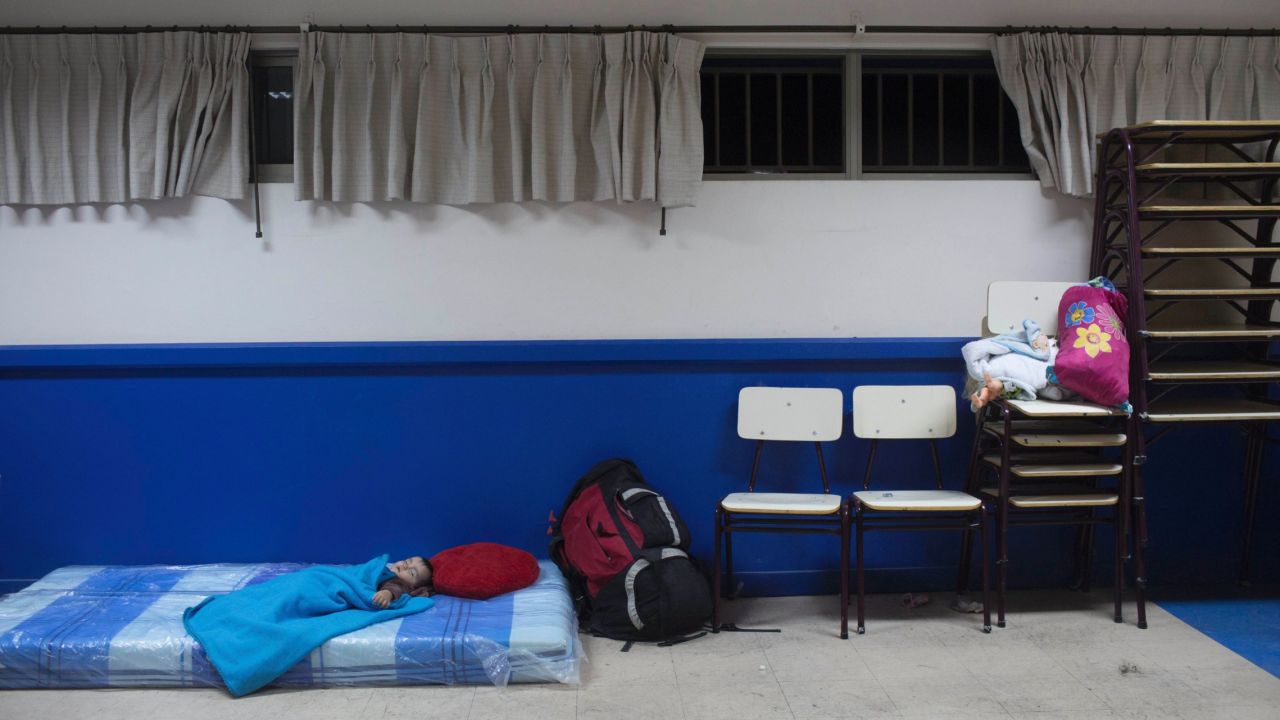 A boy sleeps on a mattress at a school in Chanaral on March 26. Fears of mudslides prompted authorities to evacuate thousands from their homes.