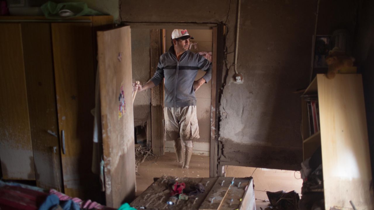 A man cleans his flooded home in Copiapo on March 26.