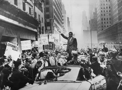 Nixon's campaign slogan was "For the Future." He waves to the crowds with his wife, Pat, as he leaves the Hotel Commodore in New York on September 30, 1960. 