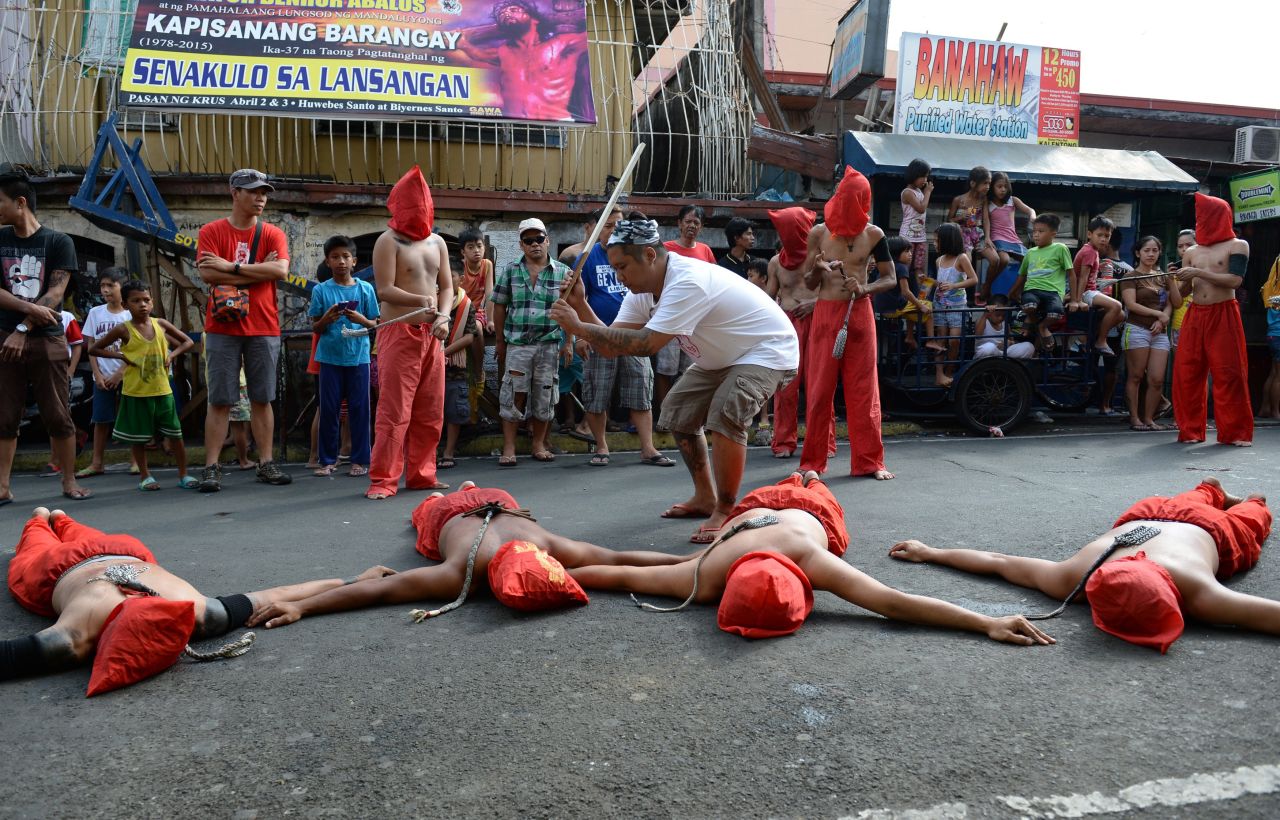 A man whips penitents during celebrations on April 2, 2015.