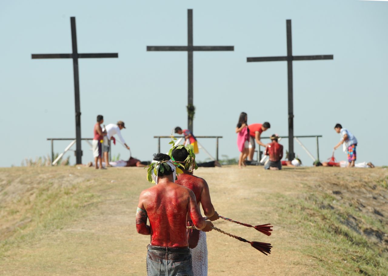 Penitents walk towards crosses as they whip themselves on April 3, 2015.