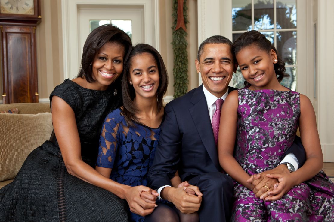 President Barack Obama, first lady Michelle Obama, and their daughters, Malia, 13, (left) and Sasha, 10, sit for a family portrait in the Oval Office, December 11, 2011. 