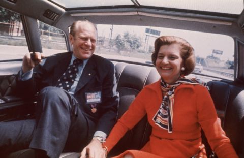 President Gerald Ford and first lady Betty Ford sit in the back seat of a car in 1975. Ford's 1976 campaign slogan was, "He's Making us Proud Again."