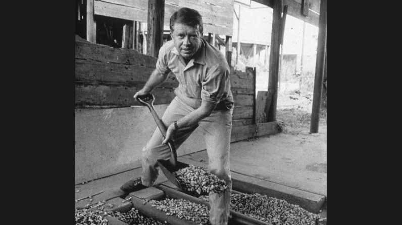 Jimmy Carter looks up while shoveling peanuts on a peanut farm sometime in the 1970s. Carter was a peanut farmer, and "Not Just Peanuts" was one of his campaign slogans during the 1976 presidential election.