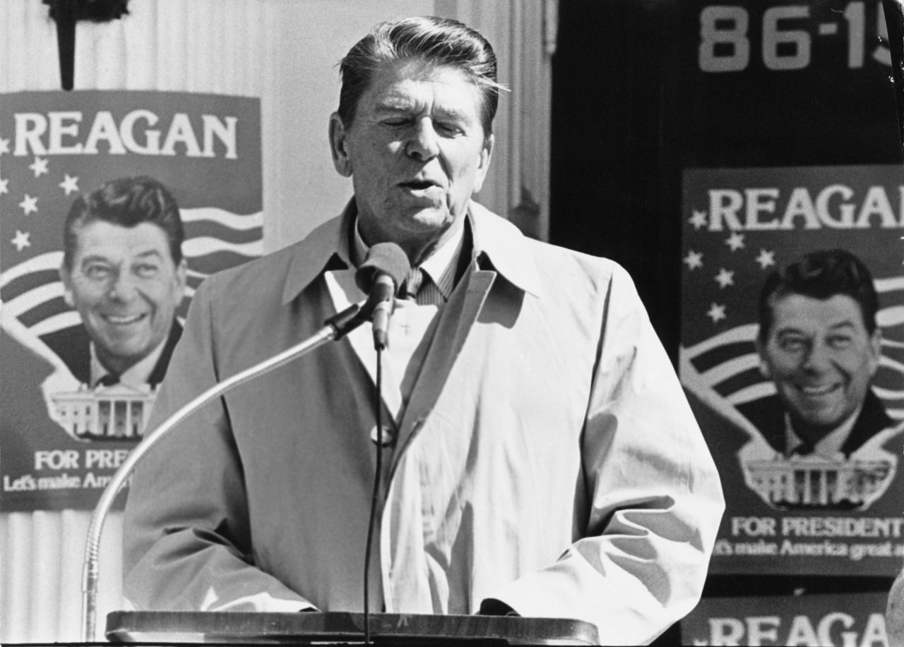 Behind Ronald Reagan are campaign posters with one of his most famous slogans: "Let's make America great again." 