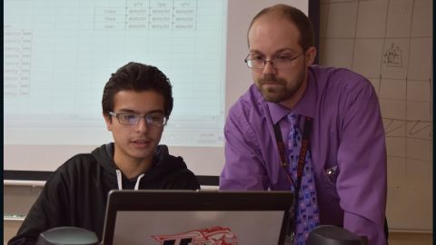 Huntley High School student Johnathan Sanabria and biology teacher Ryan Marsh model how organisms evolve over time. The school's blended learning program combines online and in-person education.
