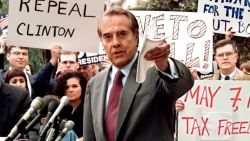 Republican presidential candidate U.S. Senator Bob Dole (center) pushes for a repeal of the 4.3 cent gas tax during a rally in front of the Internal Revenue Service, as he campaigned against President Bill Clinton. Dole's campaign slogan was "The Better Man for a Better America."