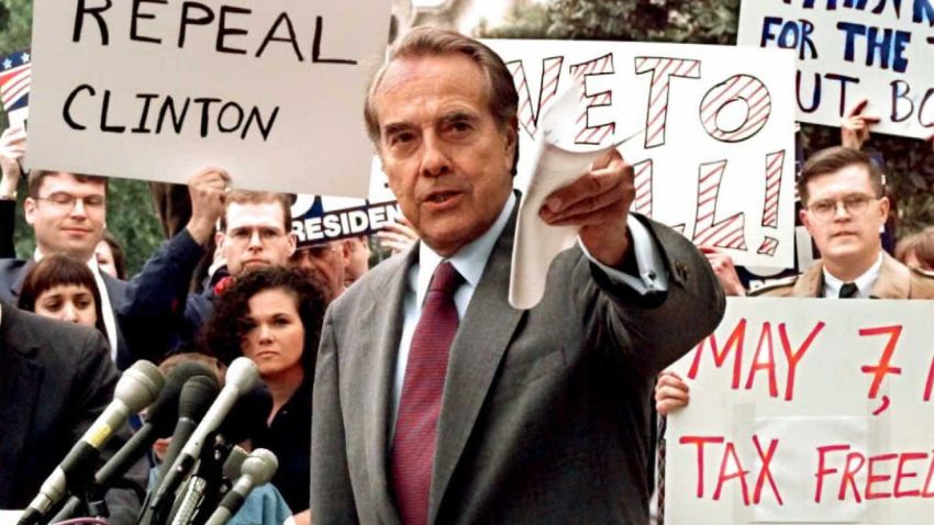 Republican presidential candidate U.S. Senator Bob Dole (center) pushes for a repeal of the 4.3 cent gas tax during a rally in front of the Internal Revenue Service, as he campaigned against President Bill Clinton. Dole's campaign slogan was "The Better Man for a Better America."