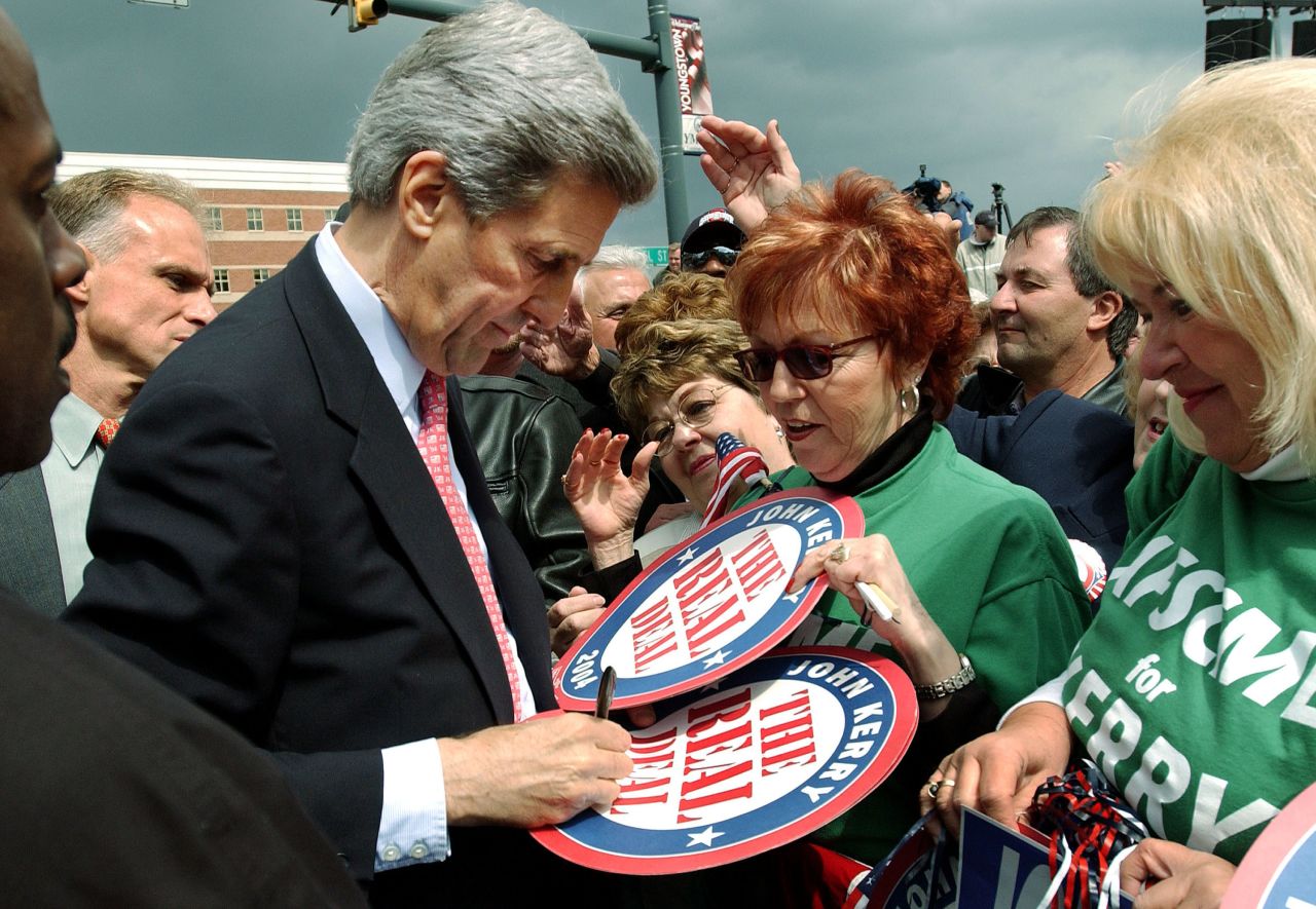 John Kerry signs "The Real Deal" campaign posters for supporters after a rally on April 27, 2004, in Youngstown, Ohio.
