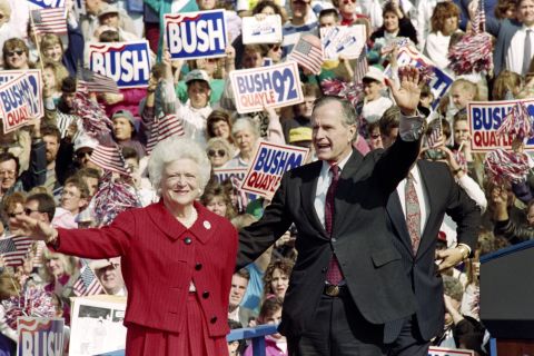 President George H.W. Bush and first lady Barbara Bush wave to supporters on October 12, 1992, at a campaign rally in Springfield, Pennsylvania. Buttons and posters that read "Stand by the President" and "Let's Stand by our Desert Storm Commander-in-Chief" were popular during his re-election campaign.