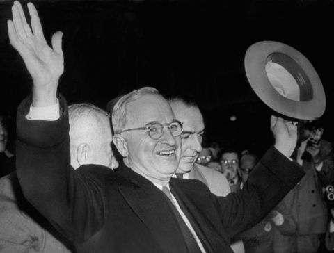 President Harry S Truman smiles and waves to the excited Kansas City crowd after hearing the news that he had won the election to retain the presidency in 1948. Truman famously adopted the slogan "Give 'em Hell, Harry!" after a supporter yelled the phrase during a campaign event.