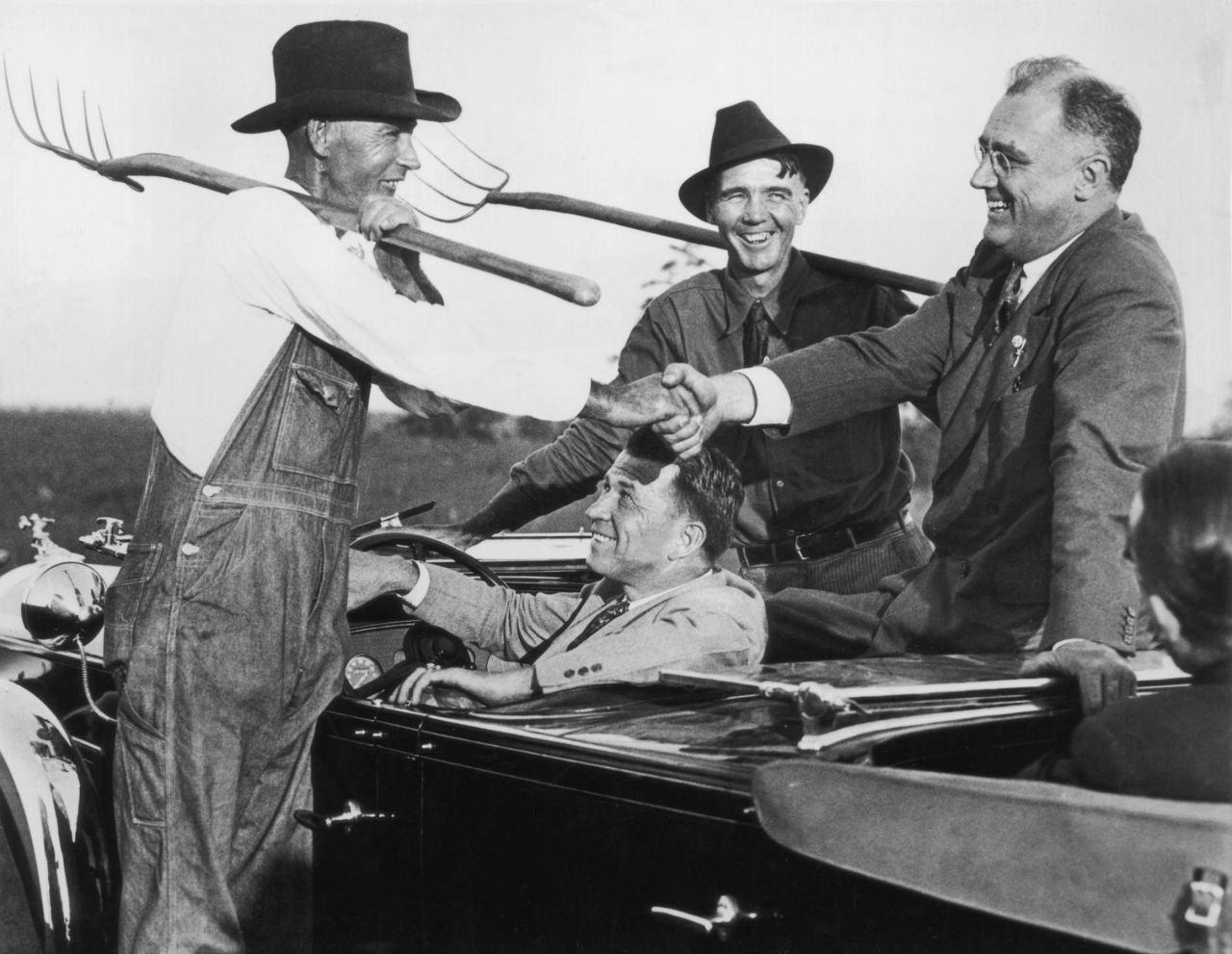 Roosevelt chats to two Georgia farmers in 1932, the first year he was elected president. During his first campaign for the presidency, he used the slogan, "Happy days are here again."