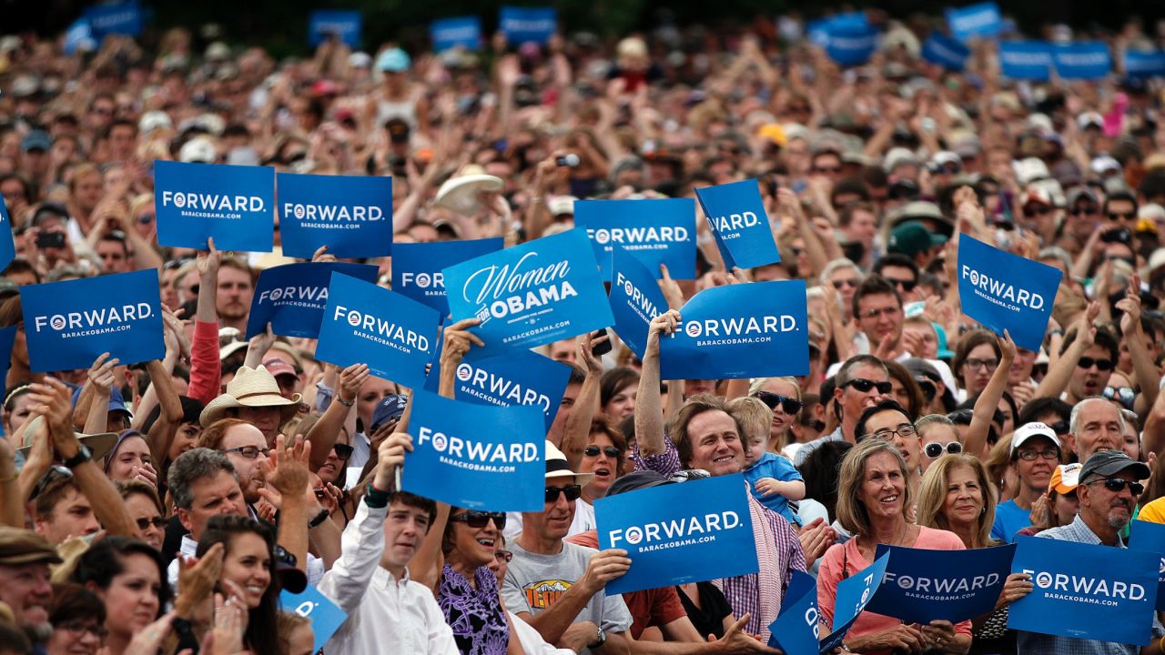 Supporters wave "Forward" signs as President Barack Obama speaks at a rally on September 2, 2012, in Boulder, Colorado.