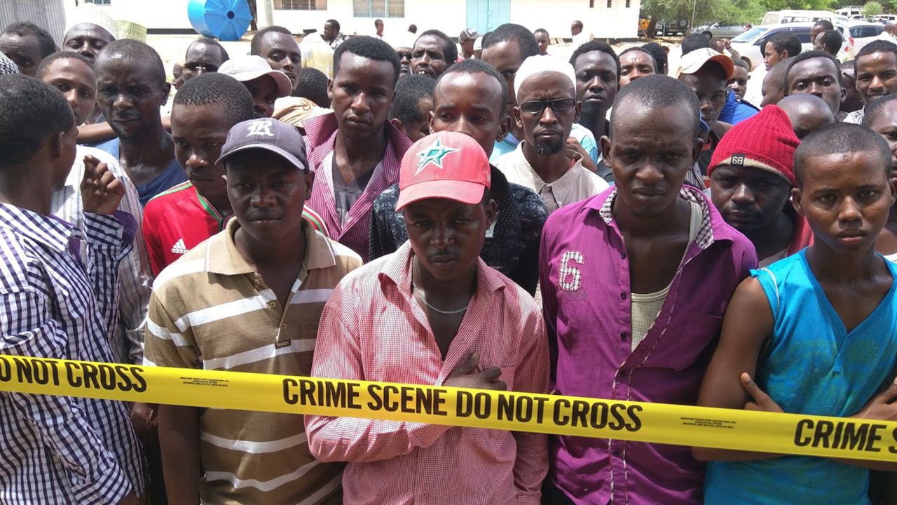 Crowds stand at the police crime tape outside Garissa University College.