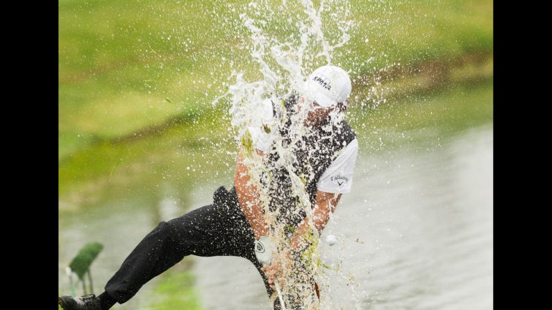 Phil Mickelson blasts the ball out of the water Sunday, April 5, on the last hole of the Shell Houston Open. He finished tied for 17th in the tournament, which was won by J.B. Holmes in a playoff.