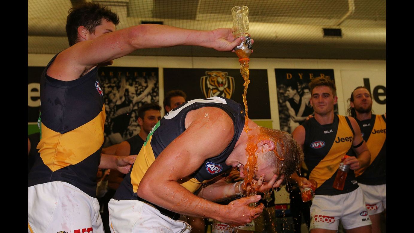 Taylor Hunt has a sports drink poured on him by a teammate after the Richmond Tigers won the season-opening match of the Australian Football League on Thursday, April 2. The Tigers defeated the Carlton Blues by 27 points in Melbourne.