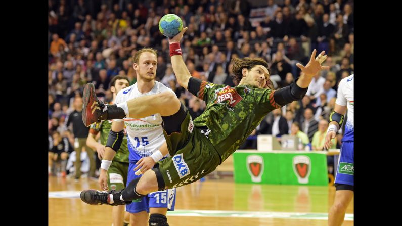 Evgeni Pevnov of Fuchse Berlin throws the ball while playing HSV Hamburg in a Bundesliga handball match Wednesday, April 1, in Berlin.