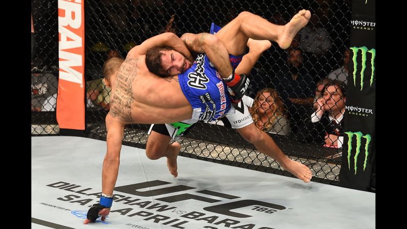 Clay Guida takes down Robbie Peralta in their UFC bout Saturday, April 4, in Fairfax, Virginia. Guida won the featherweight fight by unanimous decision.