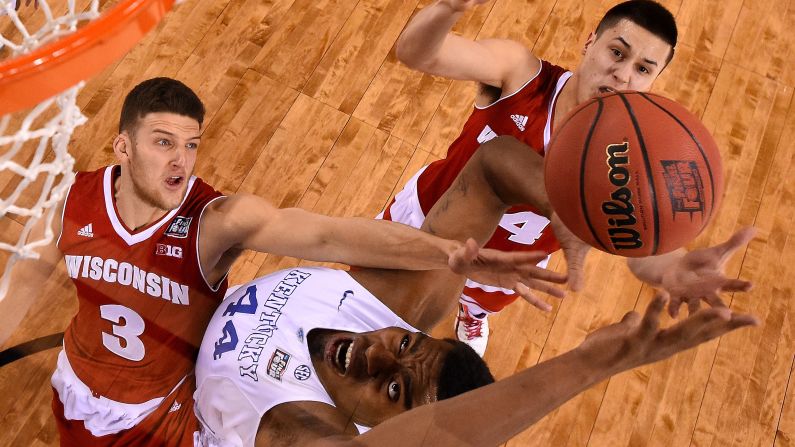 Kentucky's Dakari Johnson goes up for the ball near Wisconsin's Zak Showalter, left, and Bronson Koenig during their Final Four game Saturday, April 4, in Indianapolis. Wisconsin won the game 71-64, handing Kentucky its first loss of the season.