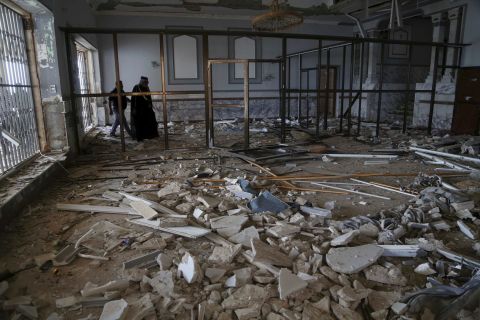 People in Tikrit inspect what used to be a palace of former President Saddam Hussein on April 3.